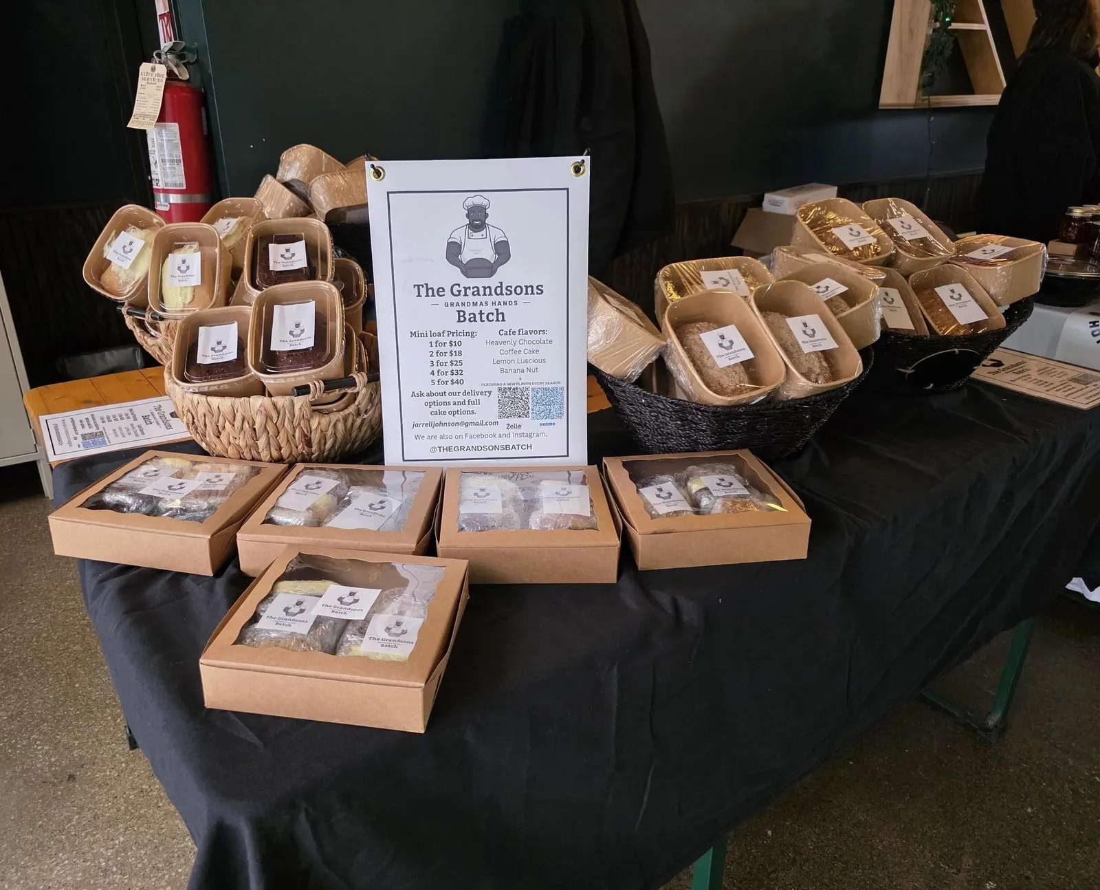 A Grandsons Batch market table displaying packaged mini loaves and family-recipe baked goods